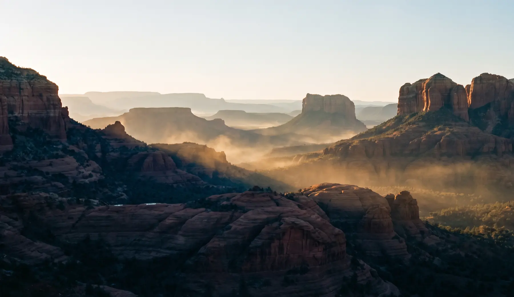 Sedona canyon at first light, mist between the buttes