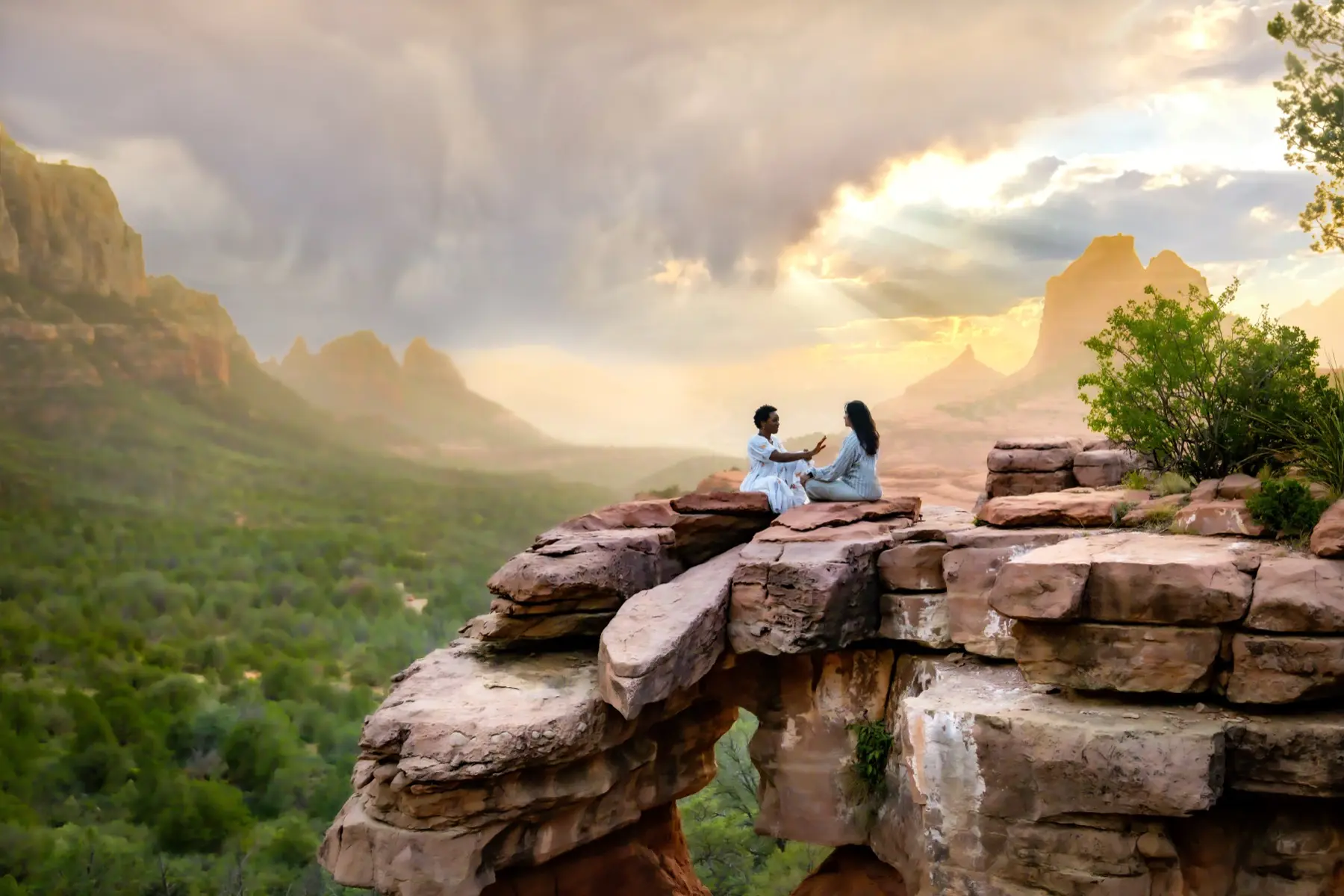 Two practitioners in session on a cliff edge above the valley